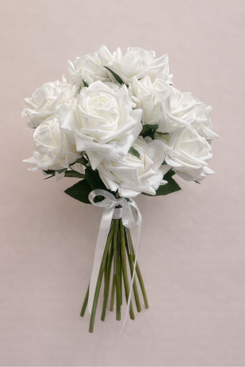 Close-up of white real touch roses in an artificial bridal bouquet