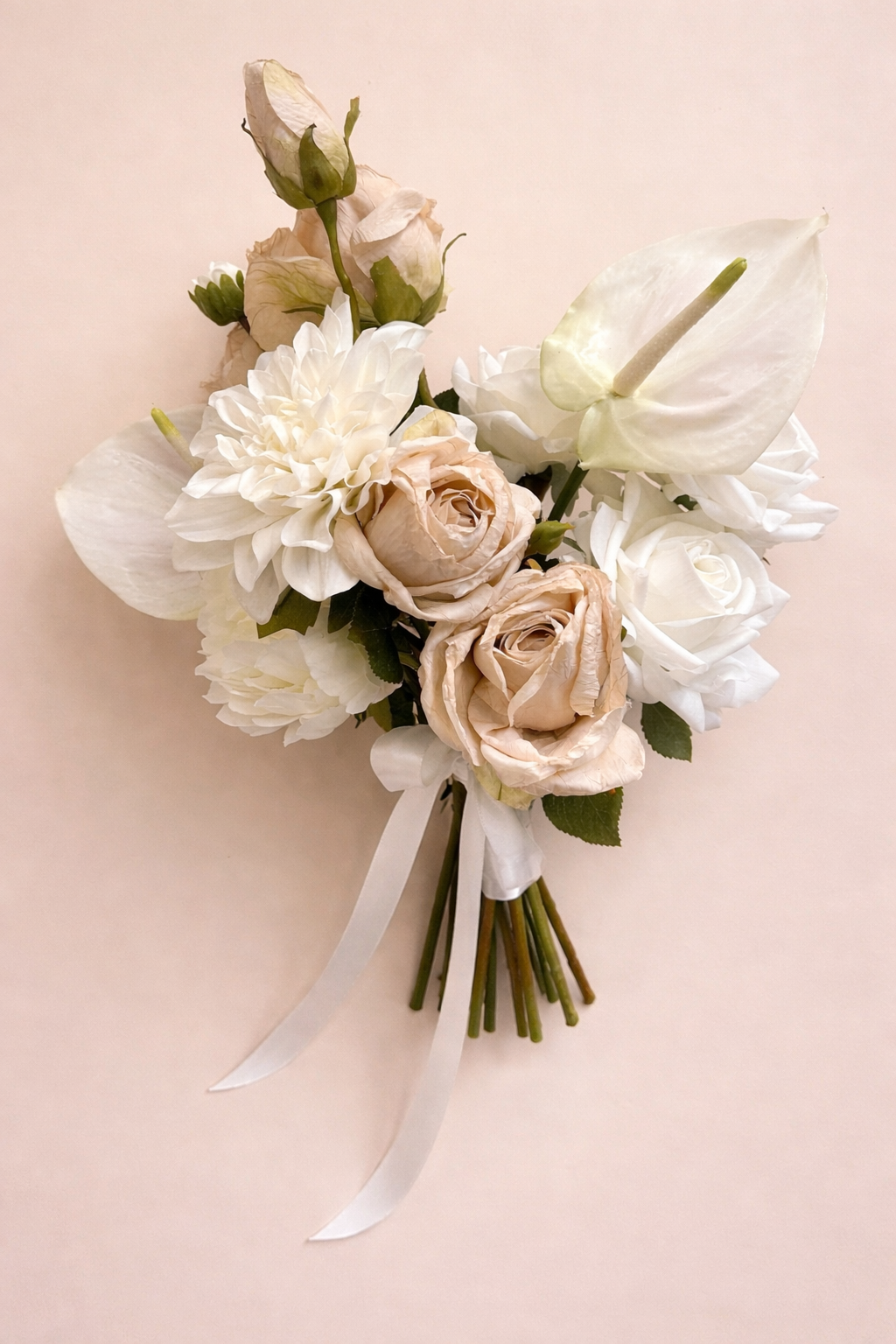 Close-up of nude rose, creamy dahlia and peony flowers in an artificial bridal bouquet