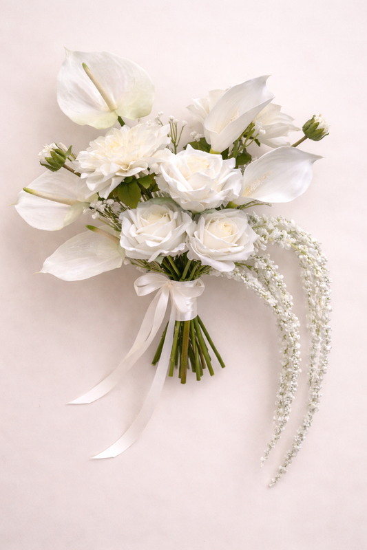 Artificial anthurium and calla lily bridal bouquet featuring white artificial real touch roses on a neutral back ground